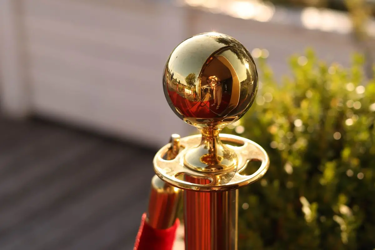 Gold stanchion post with red velvet rope